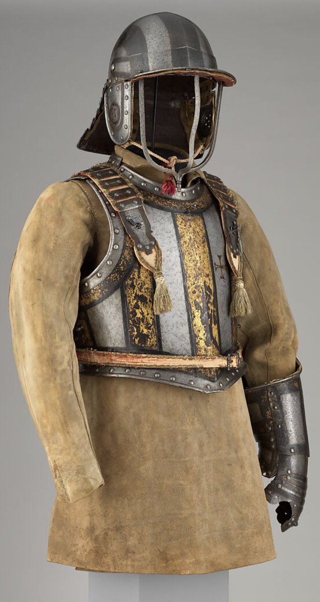 Argonaut1535's tweet photo. 🇵🇹🇬🇧Etched & Gilt Harquebusier's Armor of Pedro II, King of Portugal (reigned 1683–1706) with Buff Coat

Made in London by the British Armorer Richard Holden ca. 1683

This armor can be identified by its decoration as having belonged to Pedro II (reigned 1683–1706). The decoration includes the crowned monogram PR for Pedro Rex (Pedro the King) and the cross of the commander of the Order of Christ, a hereditary office held by the kings of Portugal.

Harquebusiers were armored cavalrymen generally equipped with a carbine (known as a harquebus) carried at the right side on a shoulder belt, a pair of pistols holstered at the front of the saddle, and a sword. 

This form of armor, consisting of a triple-barred helmet, a cuirass with a bulletproof reinforcing breastplate, and an elbow gauntlet, was commonplace in England up to about 1645. 

The armor of King Pedro is significant not only as a very late example of this type but also as the probable work of the London armorer Richard Holden. 

A very similar armor made by Holden in 1686 for James II of England (reigned 1685–88) is in the Royal Armouries in the Tower of London.

The armor is shown with an associated buff coat. This sturdy leather defense, which provided effective protection against sword cuts, was worn throughout the seventeenth century, first in conjunction with armor and later alone.

Dimensions: armor (15.113.1–.5): Wt. 43 lb. 5 oz. (19.6 kg)