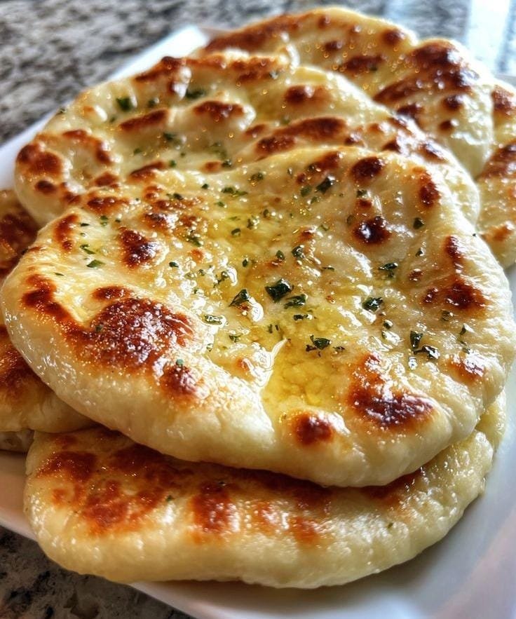vitalnibbles's tweet photo. 🧄🫓 Garlic Naan 😋
 Ingredients :
 🌾 2 cups all-purpose flour
🥛 ½ cup plain yoghurt
💧 ¼ cup warm water
🥄 1 tsp instant yeast
🍚 1 tsp sugar
🧂 ½ tsp salt
🧈 2 tbsp melted butter
🧄 3 cloves garlic (minced)
🌿 Fresh coriander

 Method:
1️⃣ Mix flour, yeast, sugar, salt, yoghurt, and warm water to form a soft dough. Knead well and let it rise for 1 hour. ✨
2️⃣ Divide into balls and roll each one into a thin oval. 🫓
3️⃣ Cook on a very hot pan for 1–2 minutes per side until puffed and golden. 🔥
4️⃣ Mix melted butter with garlic and brush generously over the hot naan. 🧄🧈
5️⃣ Sprinkle with fresh coriander and serve warm.