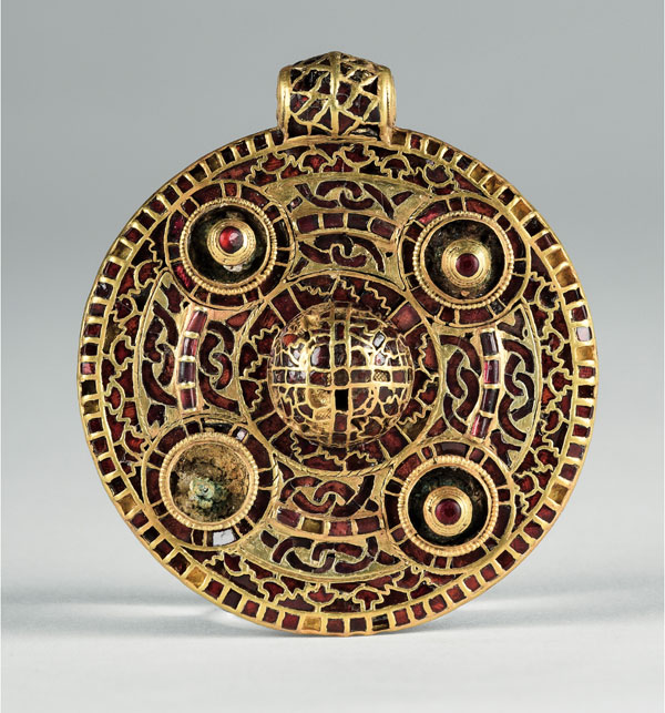 AngloSaxonPast's tweet photo. This detectorist found a bowl-and uncovered a woman buried in gold

In 2014, metal detectorist Tom Lucking found a bronze bowl in a field at Winfarthing, near Diss in Norfolk. Realising it might belong to a grave, he did something crucial: he covered it back up and called archaeologists instead of digging further.

The grave they uncovered belonged to seventh-century Anglo-Saxon England, during a period when Christianity was spreading through East Anglia but older burial customs had not simply vanished overnight.

Inside lay the partial remains of a woman, probabyl over 40 and perhaps over 50. Around her was jewellery extraordinary enough to suggest very high status: gold beads, two Frankish coins turned into pendants, a small cross-decorated pendant and a great circular gold ornament covered with more than 400 tiny garnets.

Some of those stones probably travelled from Asia before reaching the hands of the goldsmith who fitted them into tiny cells of gold. The coins had been made across the Channel during the reign of the Frankish king Sigebert III.

So an apparently quiet Norfolk field had produced a woman connected to a much wider world.

The cross matters too. It points towards Christianity, but she was still buried with jewellery, a knife, a pottery vessel and other possessions. Conversion was not a switch that everybody flicked in exactly the same way.

Then the bronze bowl that began the whole discovery yielded another clue.

Analysis found traces of plants including foxglove, horsetail, bracken and birch bark. Several have long associations with healing, although that cannot prove she herself was a healer. Their flowering seasons also suggest the burial took place in early summer.

Even stranger was the location. No important Anglo-Saxon settlement was known at Winfarthing when the grave appeared.

Later investigation found other graves nearby. What had looked like one isolated rich burial was part of a cemetery, in a landscape shaped like a natural amphitheatre around springs. Researchers have even identified evidence suggesting earlier Roman ritual activity nearby.

Testing of the woman’s remains has since suggested she may have spent her childhood in continental Europe, possibly around the Rhineland. That remains an interpretation rather than a name or biography.

We still do not know who she was.

But one careful decision in a muddy field preserved something better than a guess: a grave showing a wealthy woman carrying Christianity, continental connections and older burial traditions with her into the ground.