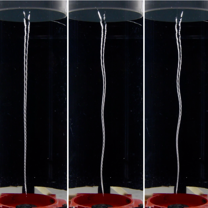 A series of three side-by-side photos capture Kelvin wave turbulence along an air-water vortex filament. A 40-centimeter-long vortex set against a black backdrop is bounded on the bottom by a red tube and on the top by an immersed gray annulus, where the vortex is forced by gentle random horizontal oscillations — generating interacting Kelvin waves that transport energy along the filament.