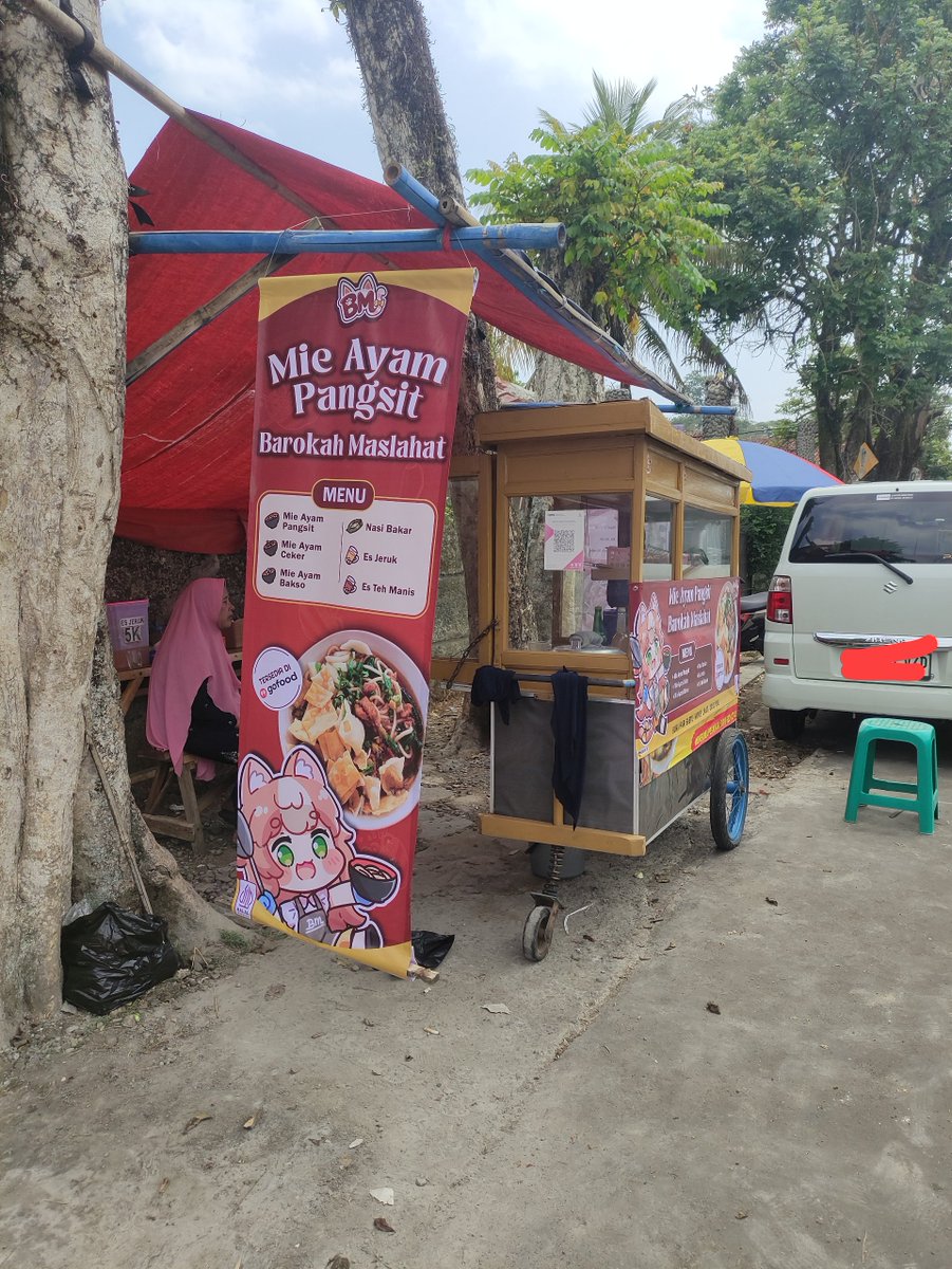 Rutorifuki's tweet photo. Mom: "can you design a simple banner for the mie ayam stall?"

Me: *proceeds to add anime cat waifu mascots and stickers* https://t.co/6yYgqUTlxh
