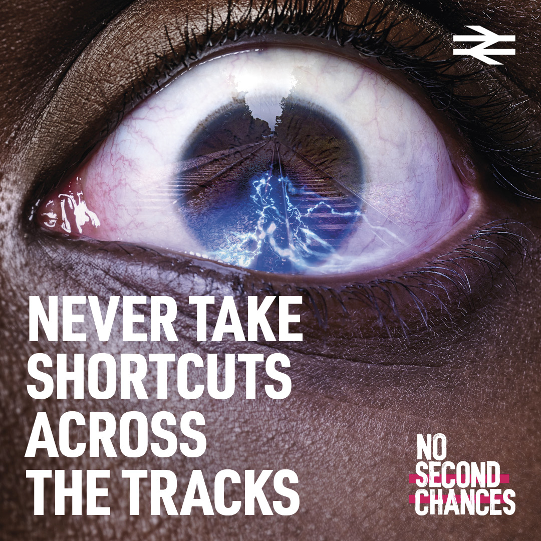 An eye reflecting train tracks and power lines. Text reads: "Never take shortcuts across the tracks" and "No second chances." The British Rail logo is in the top right corner.