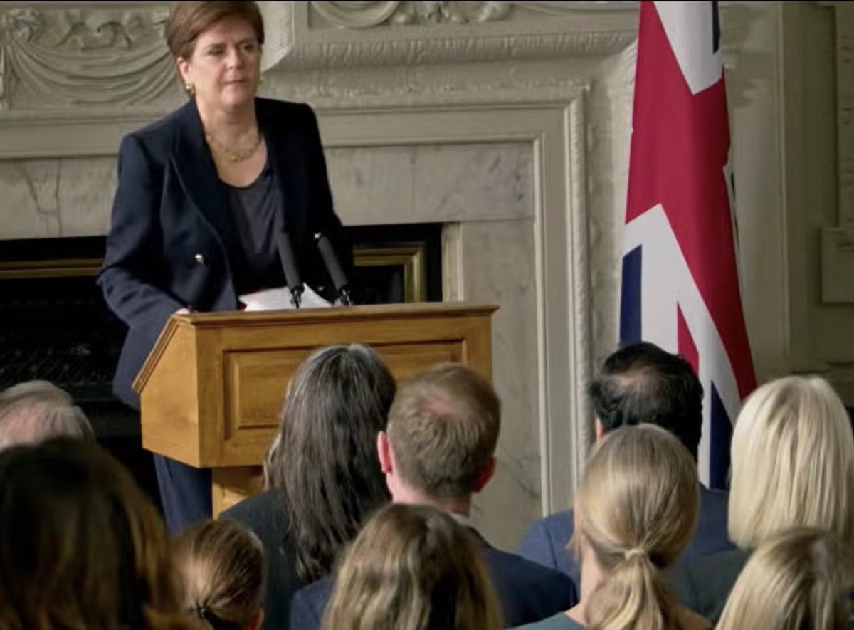 Honeythedog1's tweet photo. I think this is what they mean by “selling out.” Even as the grasping narcissist #Sturgeon poses in front of the dreaded “butchers apron” as nationalists call it ,her  drones and sycophants must be on suicide watch over her antics. She told them to #Savethedate. Thick fcuks. https://t.co/FPz87pIs99