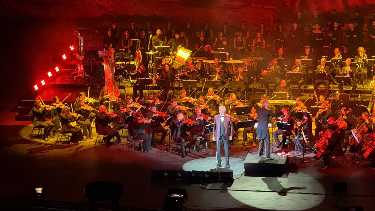 atKenNelson's tweet photo. Andrea Bocelli, at the Red Rocks Amphiteater in Denver, was amazing.  It was more of a variety show where he surrounded himself with talent of the highest order. His own orchestra, conductor, the best dancers, the best accompanists, and soloists (singing and violin). 

2 encores, 6 curtain calls.   

First it was opera, him, him with accompanyists, and some soloists doing stuff most people "know" but don't "know".  

Then hits from his career, him solo and with accompanists, and for one set just him and a piano.  

Only one song, All By Myself (an amazing rendition by Pia Moreno) was in English, but that was fine.  

Every performance, by everyone, was basically perfect.   As was my date for the night!   

The Red Rock Amphitheater, a stunning venue, was a key part of the show, as was a lighting storm behind the stage that never quite got to us.