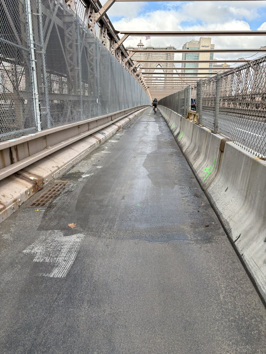 _Steve_Bennett's tweet photo. Another great @NYCMayor infrastructure fix of low-hanging fruit. After years of failed, half-hearted attempts to fix the pooling issue on the Brooklyn Bridge bike lane, @NYC_DOT regraded the roadway and now it drains. Bon voyage Lakes Gutman, Ydanis, and Polly. cc @StreetsblogNYC https://t.co/RGornM2ciy