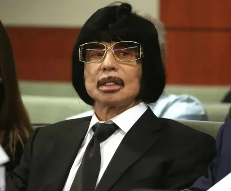 jayroo69's tweet photo. Look at this guy lol...his name is Sam Aldabbagh, he's the owner of a strip club in Las Vegas called The Can Can Room. He was on trial for running "an illegal business in violation of State law," which I can only assume involves prostitution.  Dude looks like Roy Orbison and Gene Simmons combined