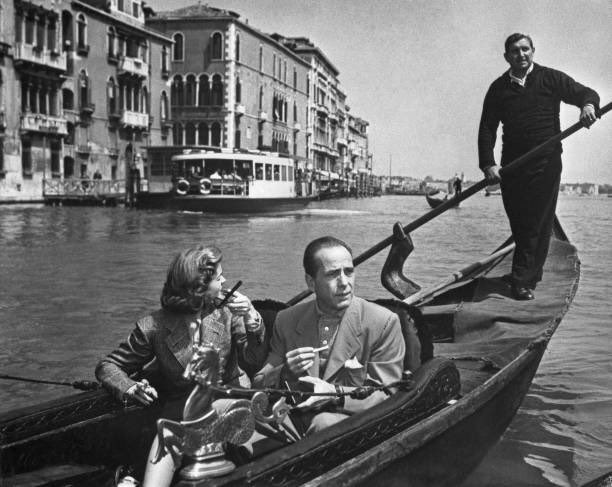 PetronellaWyatt's tweet photo. Humphrey Bogart and Lauren Bacall in Venice in 1951. It was Bacall’s first trip to Europe - the couple were en route to filming “The African Queen”, and she was ecstatic. In London, however, there had been a small incident when they had dinner with close friend David Niven, and the Duke of Marlborough had approached the actor to invite him on a pheasant shoot. When Bogie teased Niven about his “grand” friends, he had replied, “it’s not really a compliment, by this time of year, all that are left are some old cocks.” Bogart had then leapt to his feet and berated the Duke, saying, “How dare you insult my friend with your cocks.”