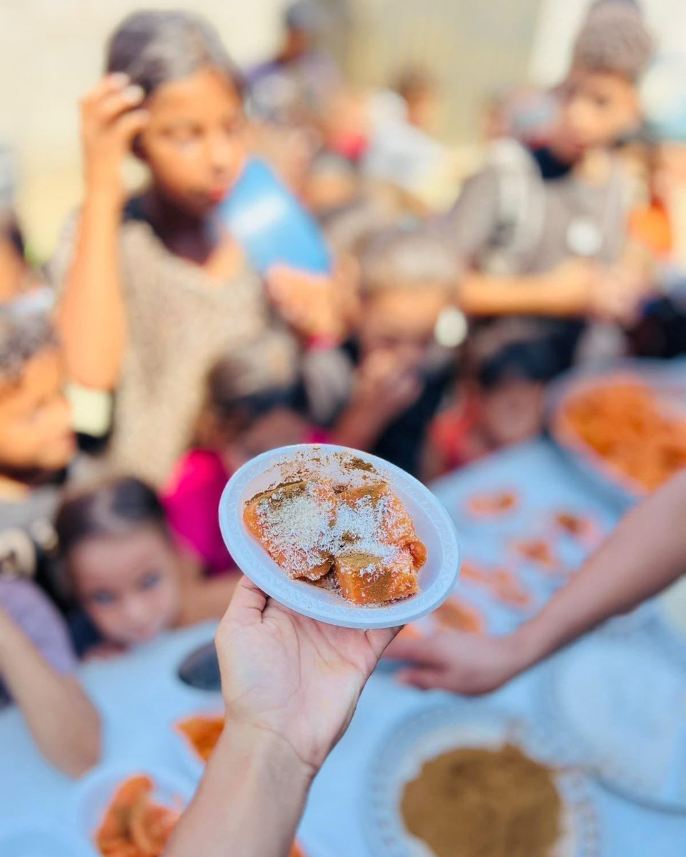 WCKitchen's tweet photo. Sweet potatoes are a beloved treat in Gaza, especially in autumn. The local soil is good for growing the nutrient-dense vegetable, and they’re a popular street food around this time of year. Teams at WCK-supported community kitchens in Khan Younis prepared and served plates of roasted sweet potatoes to children, bringing the warm, comforting flavors of the season to life. #ChefsForGaza