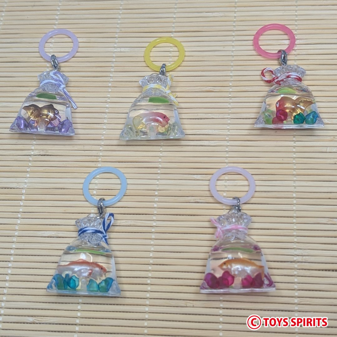 toysspirits's tweet photo. 🐟【新商品のお知らせ】🎐✨
「きらめく縁日金魚袋のめじるしコレクション」

夏の縁日で見かける
あの可愛い「金魚袋」が
めじるしチャームになりました❣️

透明感たっぷりの袋の中には
金魚とカラフルな飾りが入っていて、
見ているだけで涼しげな気分に🎐✨

ぷっくりとした金魚袋のフォルムも可愛く💞
夏祭りや金魚すくいの思い出が
よみがえるようなデザインです😍

ペットボトルや傘の持ち手、ポーチなどにつければ
自分の持ち物の目印にもぴったり🙆‍♀️💖

縁日の風情をそのまま持ち歩ける
涼しげ可愛い金魚袋チャームです💁‍♀️
#トイズスピリッツ #ガチャガチャ　#カプセルトイ
