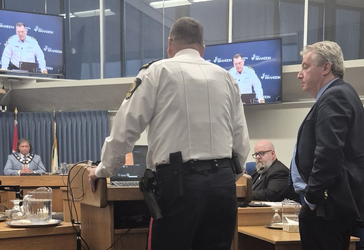 ManitobaMike204's tweet photo. Police Chief Bates fully armed for the Brandon City Hall Meeting meant to hold his police force accountable, saved by Mayor Jeff Fawcett who barred the mother of the late Cassity Delvenne from speaking. https://t.co/to9kcf2Ggr