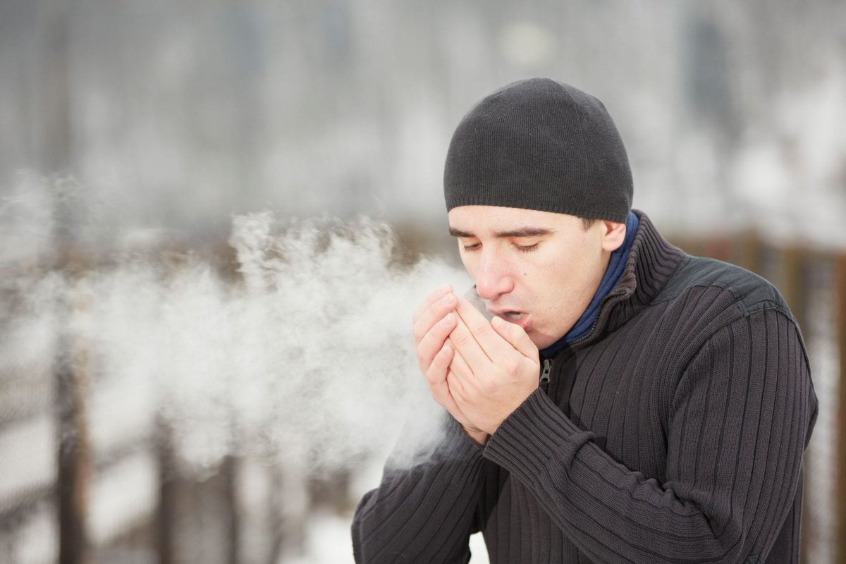 A man coughs into the cold, releasing a visible vapor in the air.

Image credit: https://stvincents.org/about-us/news-press/news-detail?articleId=17403&publicid=461