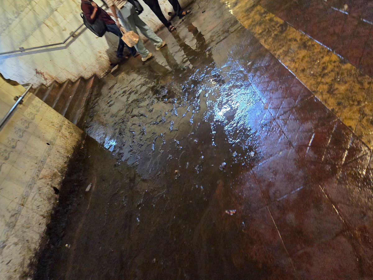 AmitPatil2023's tweet photo. The pedestrian underpass next to **Devipada Metro Station, Western Express Highway** is in a terrible state—stagnant dirty water, mud, seepage and damaged flooring are making it unsafe for pedestrians.

 @mybmc @mybmcWardRC  Take urgent action to clean, repair and maintain. https://t.co/5mYci3LPMf