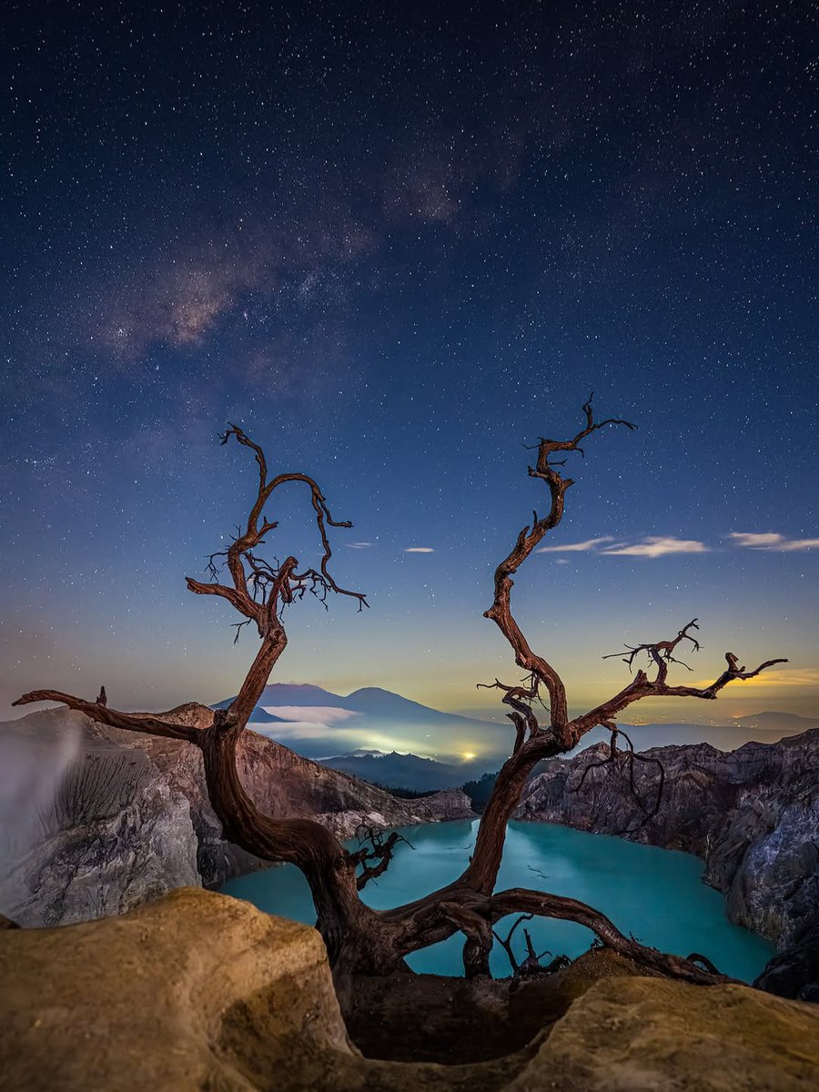 UKNikon's tweet photo. A little closer to the stars. ✨🌋

Uwe Hasubek captured the Milky Way above Indonesia’s Ijen Volcano, with a lone tree framing the scene and the volcano glowing in the distance.

Shot in the darkness with a long exposure on the Nikon Z7II.
#keepinspiring https://t.co/pE1h6MG3De