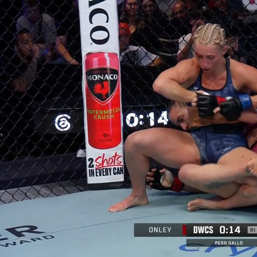 An MMA fight scene showing fighter Onley in a blue top and braided hair grappling with an opponent inside the cage, with a timer showing 0:14 and a 'DWCS' broadcast graphic indicating a Peso Gallo (Bantamweight) bout.