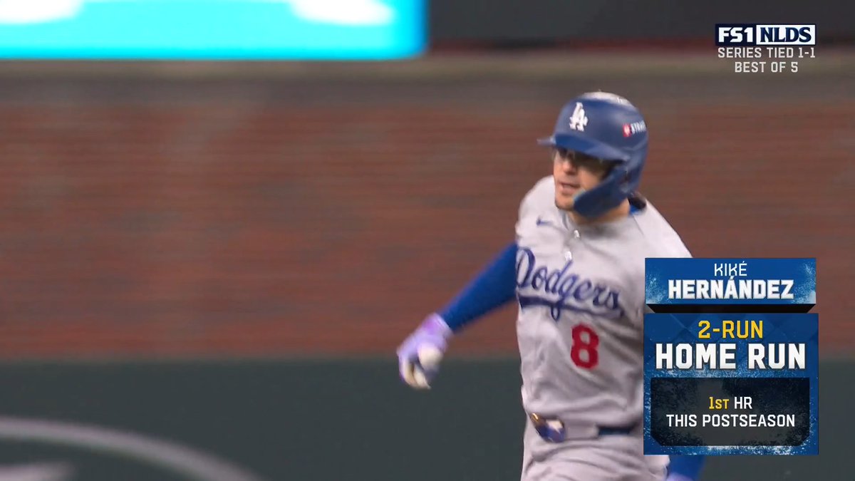 An FS1 NLDS broadcast graphic shows Los Angeles Dodgers player Kiké Hernández (#8) running after hitting a 2-Run Home Run, noted as his 1st HR this postseason, with the series tied 1-1 in a Best of 5.