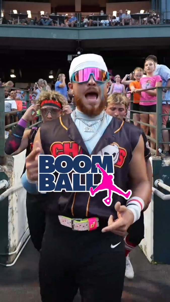 A man with a red beard and reflective sunglasses enthusiastically runs toward the camera wearing a 'Chasers' jersey, overlaid with a 'BOOM BALL' logo featuring a pink silhouette figure.