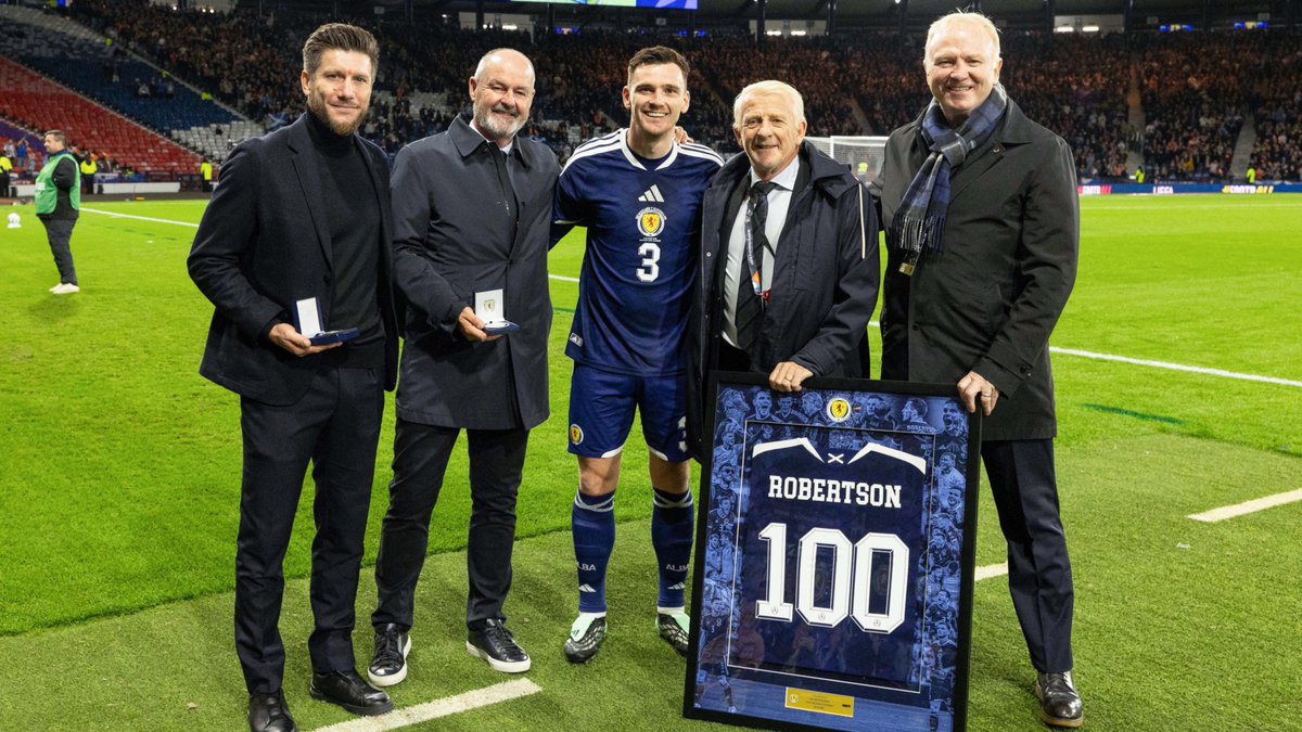 ScotlandNT's tweet photo. After winning his 100th Scotland cap on Saturday, Andy Robertson's former Scotland Head Coaches Gordon Strachan, Alex McLeish and Steve Clarke were alongside Sébastien Pocognoli pitchside to present a commemorative shirt and medal to mark the achievement 👏

#SCOSVN https://t.co/KRUudrrxzT