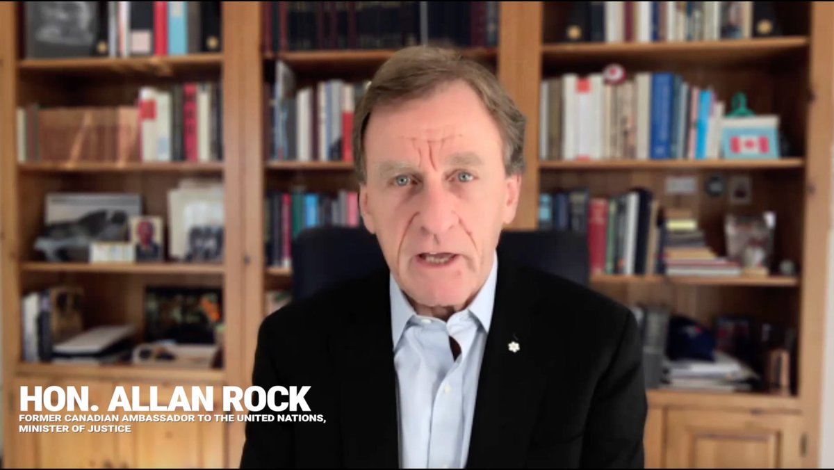 A video still of Hon. Allan Rock, identified as former Canadian Ambassador to the United Nations and Minister of Justice, speaking in front of a bookshelf.