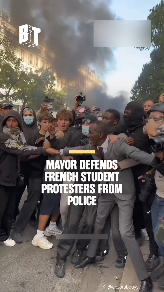 A screenshot from a news outlet "BT" with the headline "MAYOR DEFENDS FRENCH STUDENT PROTESTERS FROM POLICE" showing a confrontation scene with smoke in the background, credited to X: @enzorabouyy.