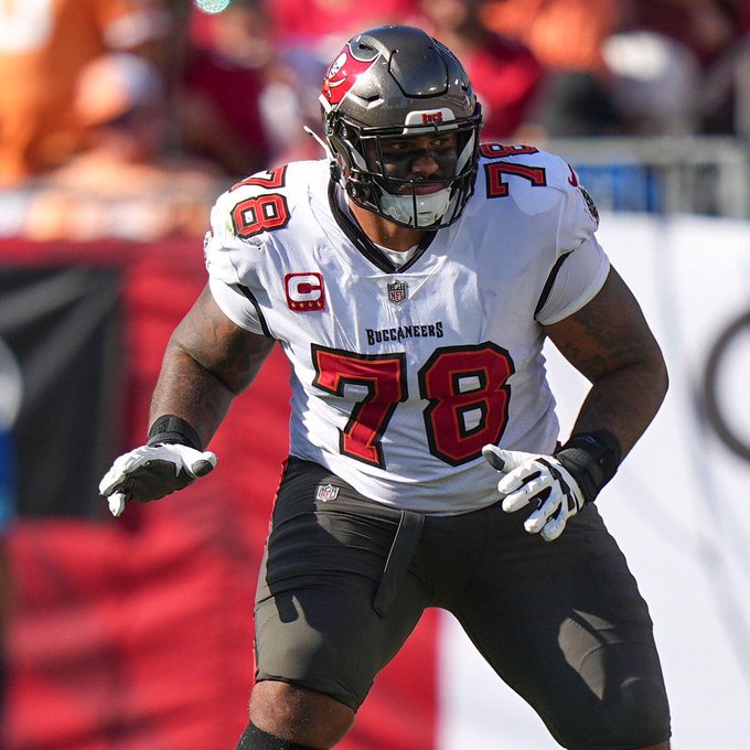 Tampa Bay Buccaneers offensive tackle Tristan Wirfs, wearing jersey #78 with a captain's "C" patch, is shown in his white away uniform in an athletic stance on the field. The image highlights Wirfs, who tops the list of NFL players with the highest pass blocking grade this season at 87.5.