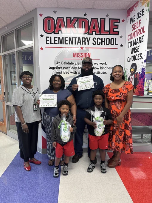 The Wilder family, standing with Dr. Ingrid Edwards and principal Kierra Ezell.