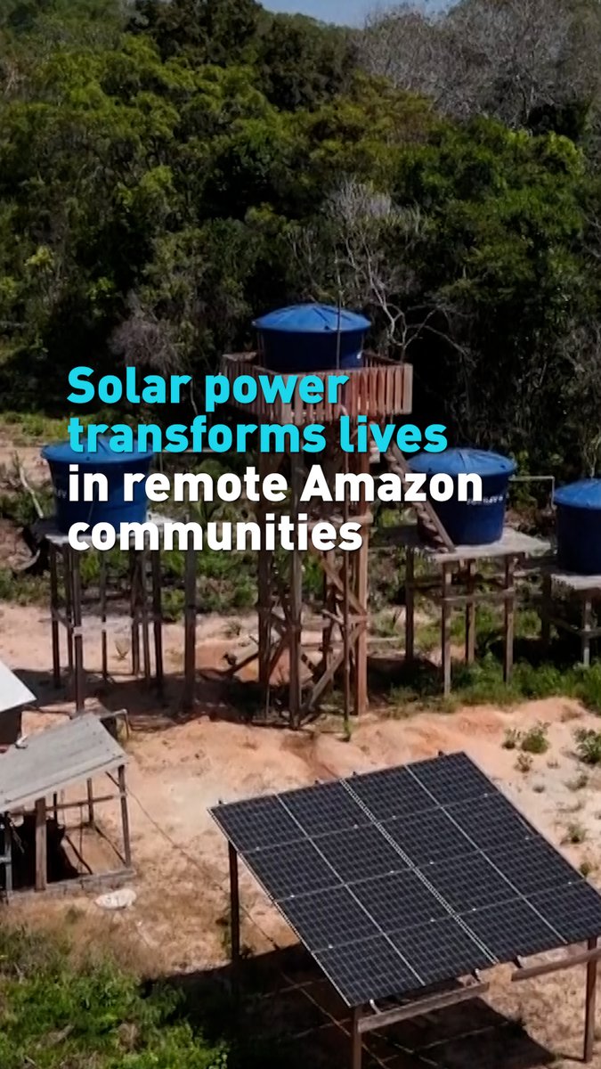An image showing solar panels and elevated blue water tanks in a remote Amazon community, with the text 'Solar power transforms lives in remote Amazon communities.'