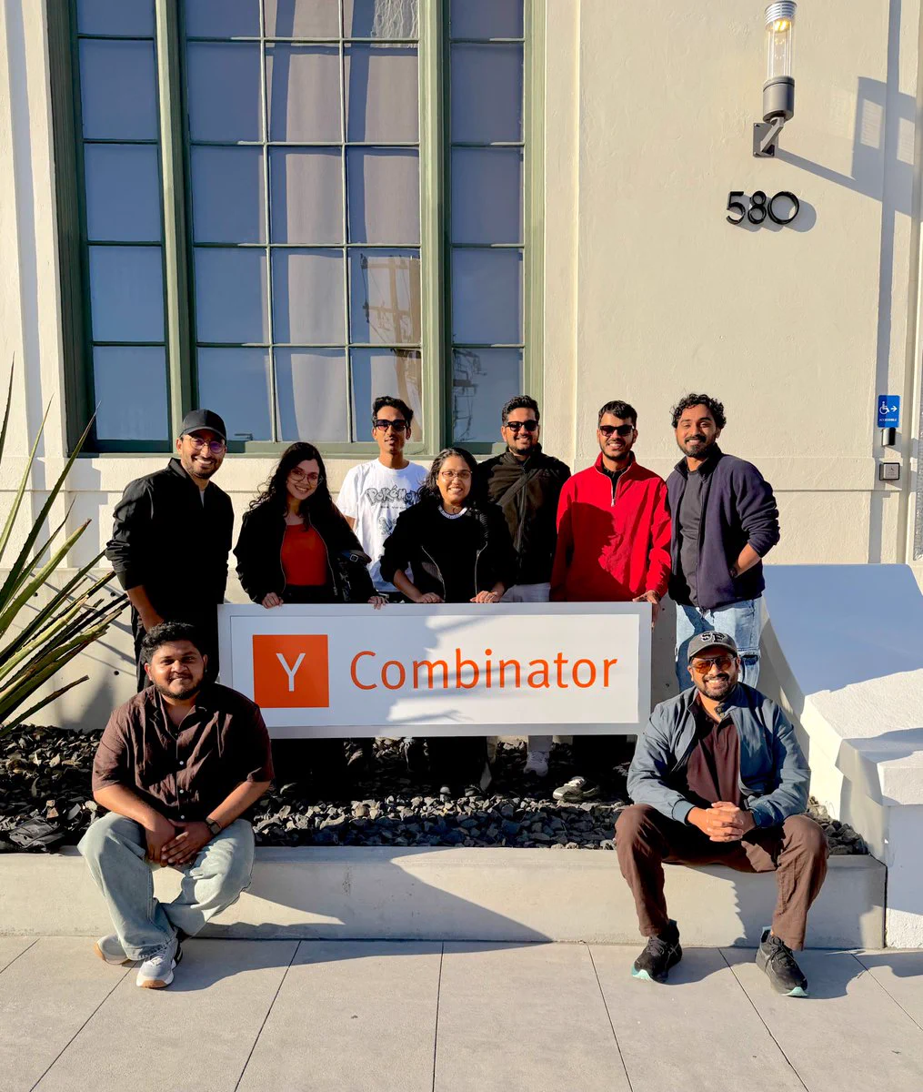 Chatwoot teammates posing together in front of the Y Combinator sign in San Francisco.