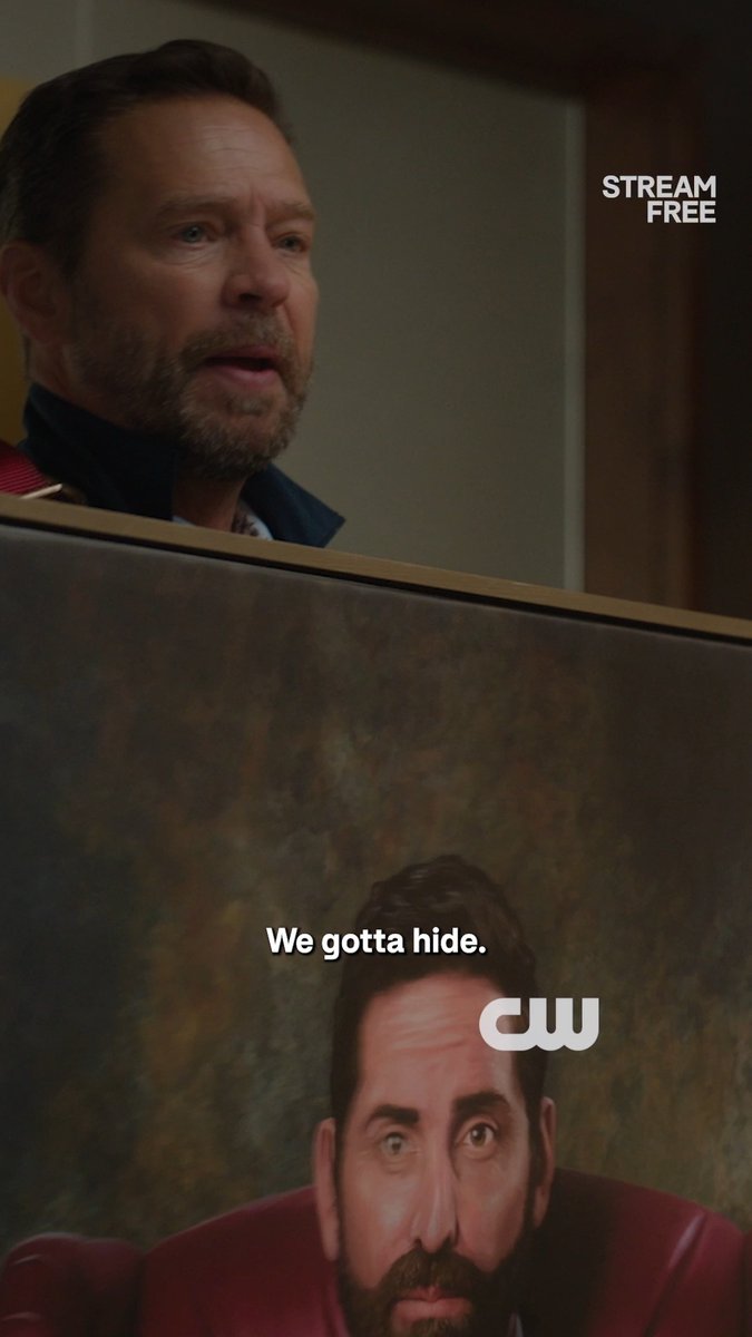 A man peers cautiously over a painting depicting another man with the caption "We gotta hide," promoting the CW series "Private Eyes" streaming free on The Roku Channel. The image humorously ties into the "Mission Impossible" theme with the tense spy-like hiding scenario.