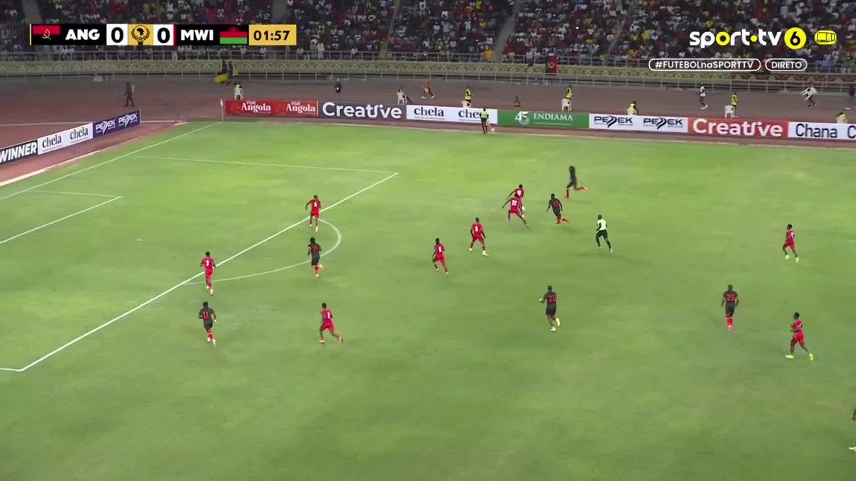 A live broadcast on sport.tv6 shows a soccer match between Angola (ANG) and Malawi (MWI) with the score tied at 0-0 at 01:57, with players in red and black kits on the field surrounded by advertising boards including "Creative" and "Endiamo" — consistent with the post announcing Angola's eventual 3-1 win in the African Nations Cup (Taça das Nações Africanas).