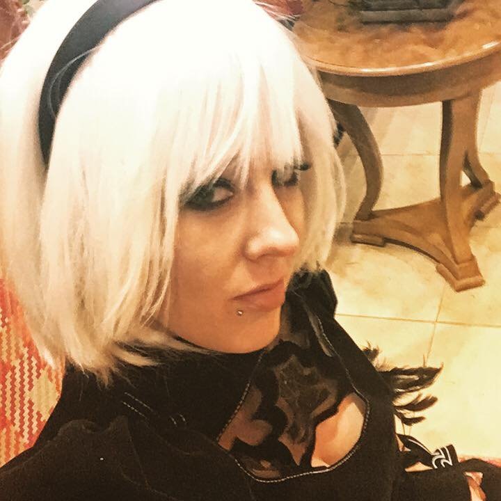 dvveet's tweet photo. BHVR most likely chose the Japanese voice actors for 2B and A2 rather than the English ones intentionally. 

Dead by Daylight tries to honor IPs in their originally intended versions / languages rather than westernized or dubbed ones. IPs such as Ringu and Tokyo Ghoul showcase this.

It's not a matter of the English actors being unobtainable either. Other Game Collaborations with NieR have utilized the English dub / actors. 
And the biggest thing... 2B's voice actor is ALREADY in DBD! Kira Buckland officially voiced Rain Carradine for the Romulus release in 2024.

For me, I personally prefer this much more than dubs since I always play games with the intended / original language and it honors the franchise(s) roots. Absolutely zero hate or discredit to the English voice dub. 

Pictured:
(1) 2B's original Japanese VA, Yui Ishikawa, cosplaying 2B.
(2) 2B's English dub VA, Kira Buckland, cosplaying 2B.