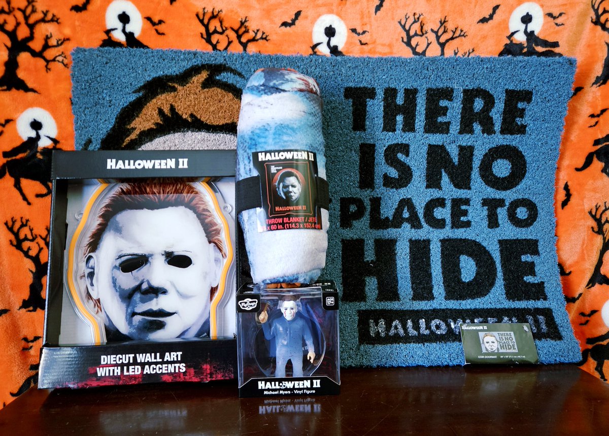 TheGhostHost's tweet photo. Check it out, y'all! The Michael Myers "There Is No Place To Hide" doormat, light-up wall hanging diecut, throw blanket, and vinyl figure prizes for the Halloween II giveaway (starting October 19th) came in today! 🎃🔪 https://t.co/OgBSIYN7US