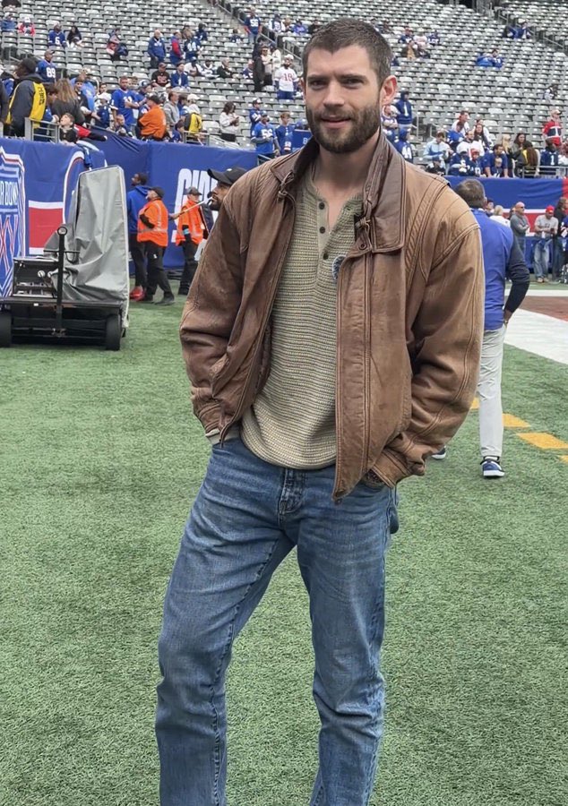popbuzzz_'s tweet photo. David Corenswet on the field at a New York Giants game, holding up a blue Giants jersey labeled “MR. IRRELEVANT” with number 38, as part of promotional press for his upcoming film.

Corenswet stars as John Tuggle, the 1983 NFL draft’s final selection by the Giants, in the biographical sports drama ‘Mr. Irrelevant’, directed by Jonathan Levine and co-starring Michael Shannon as coach Bill Parcells.

The film, scheduled for theatrical release on December 25, 2026 by Paramount, tells Tuggle’s underdog story of making the roster before his tragic death from cancer at age 25, with this event continuing the press tour after the trailer’s September release.