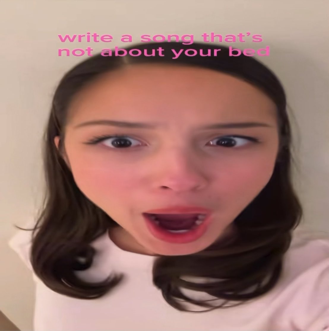 A TikTok-style video screenshot shows a woman looking into the camera with pink text overlay reading 'write a song that's not about your bed'.