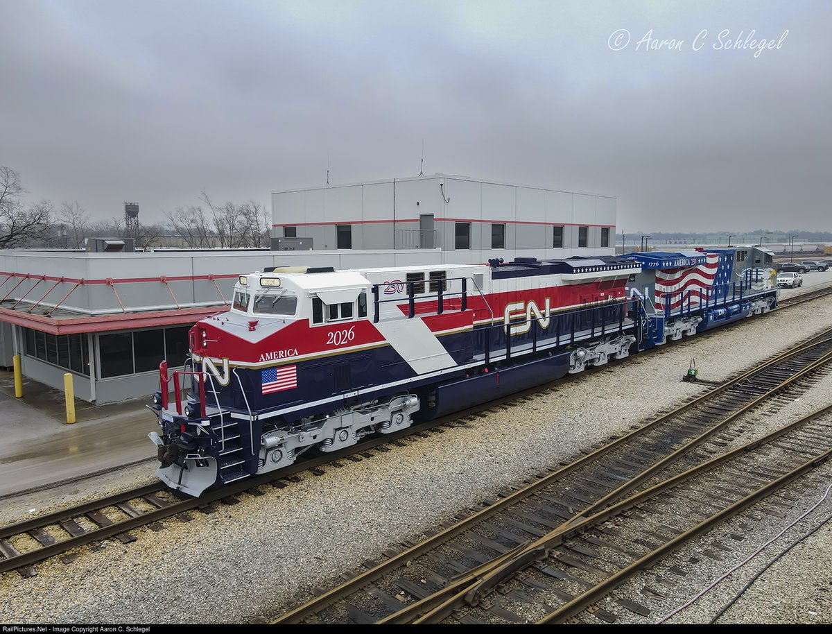 ALCOMLW's tweet photo. Wearing fresh paint (Former CitiRail) CN ES44AC 2026 "Air Force One" photographer Aaron Schlegel took this  shot at the CN Markham yard, near Homewood, Illinois March 4, 2026. Many railfans prefer this USA 250 CN Livery to more famous "Screaming Eagle" (CN 1776). (I like both for different reasons - WHB). https://t.co/1CAtvySpEG