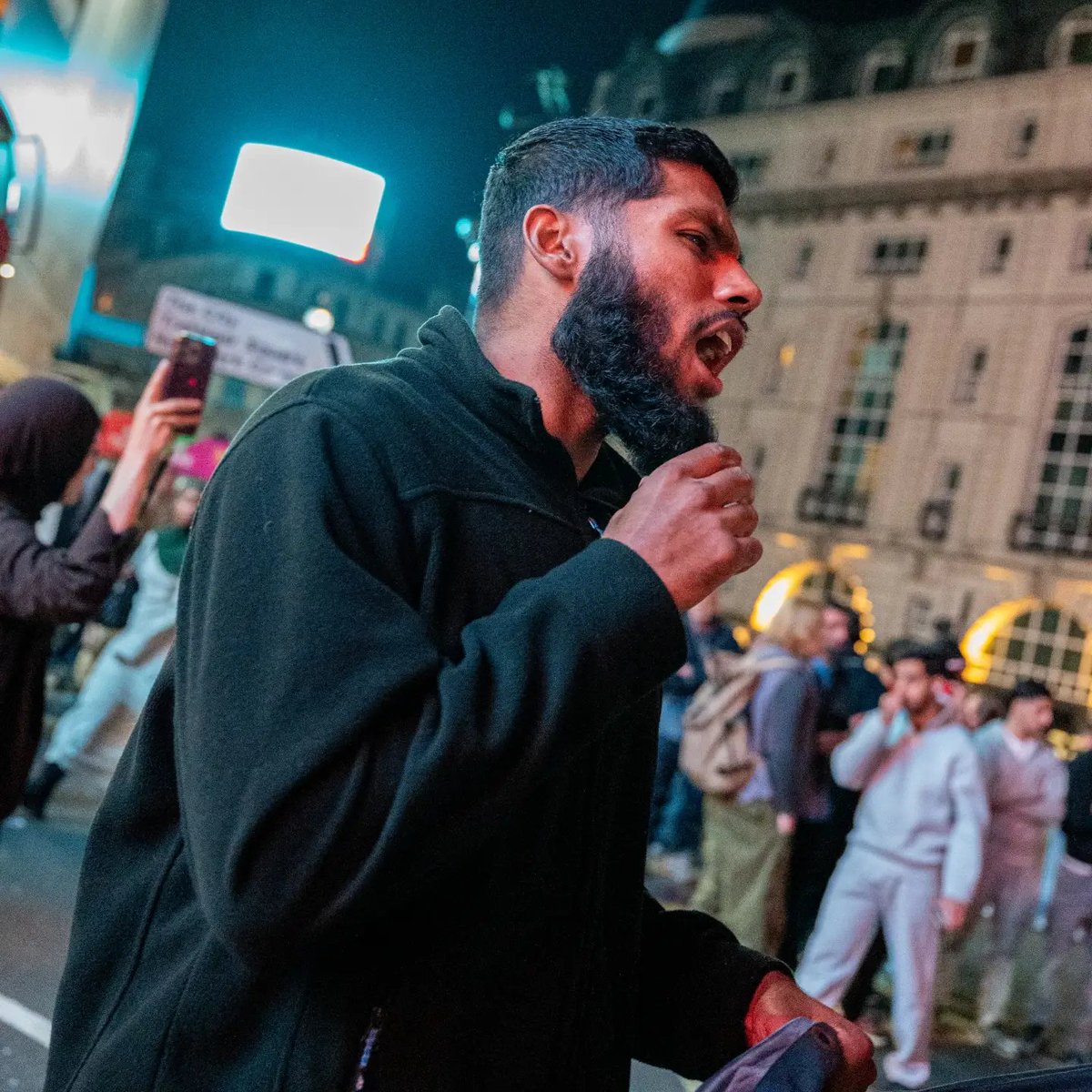 SubversiveForce's tweet photo. This is Kamran Ahmed. Last night, he was part of the mob blocking Piccadilly Circus.

He is currently on trial at Woolwich Crown Court over his alleged role in the Palestine Action attack at Filton.

Prosecutors allege his masked ‘black team’ threatened, intimidated and assaulted security guards, including by throwing fireworks and brandishing whips, hammers and large metal kebab skewers.

One guard was left with a 4cm gash to the head. It's the same attack, where a police officer was struck with a sledgehammer.

Ahmed was remanded in custody but later released on bail.

Last night showed again why he should still be spending every night in a cell.