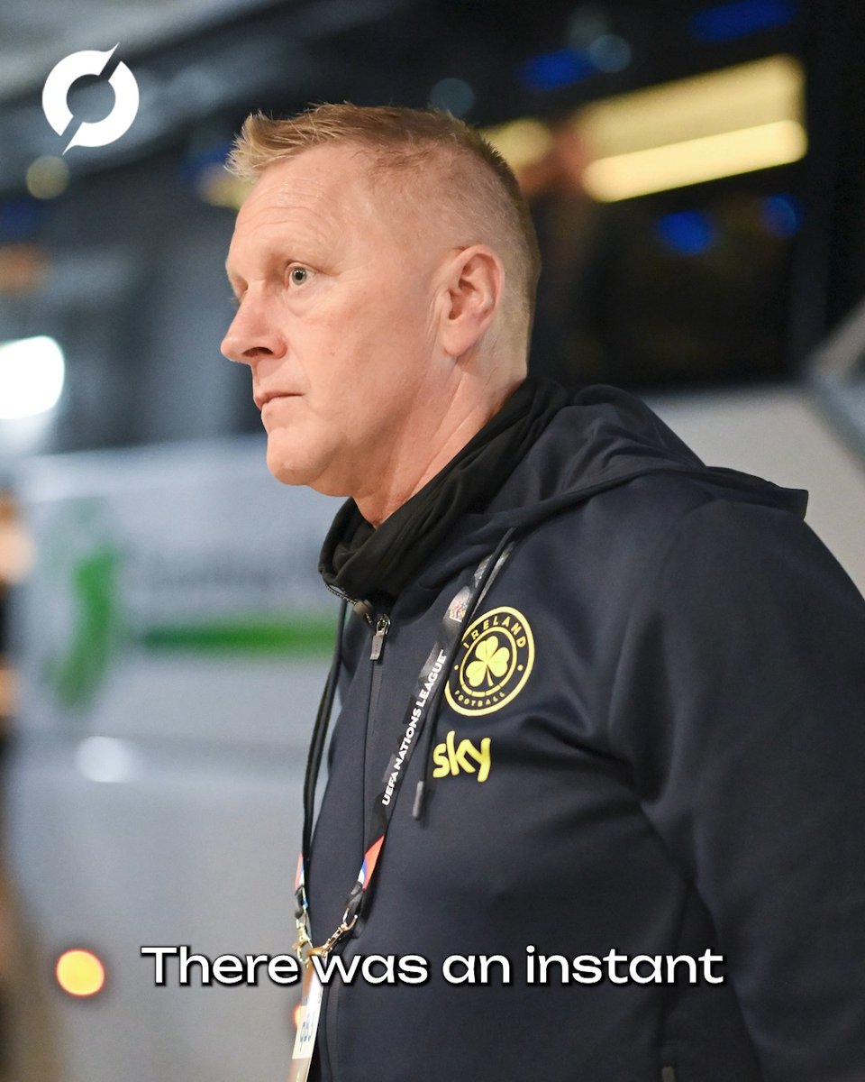 Heimir Hallgrímsson, manager of the Republic of Ireland national football team, appears serious while wearing a navy Ireland FAI hoodie with the shamrock crest and Sky sponsor logo, accompanied by a "UEFA Nations League" lanyard. The subtitle "There was an instant" suggests he is mid-statement, consistent with the post describing his confirmation of a spitting allegation and claims of Israeli intimidation during the Ireland vs Israel match.