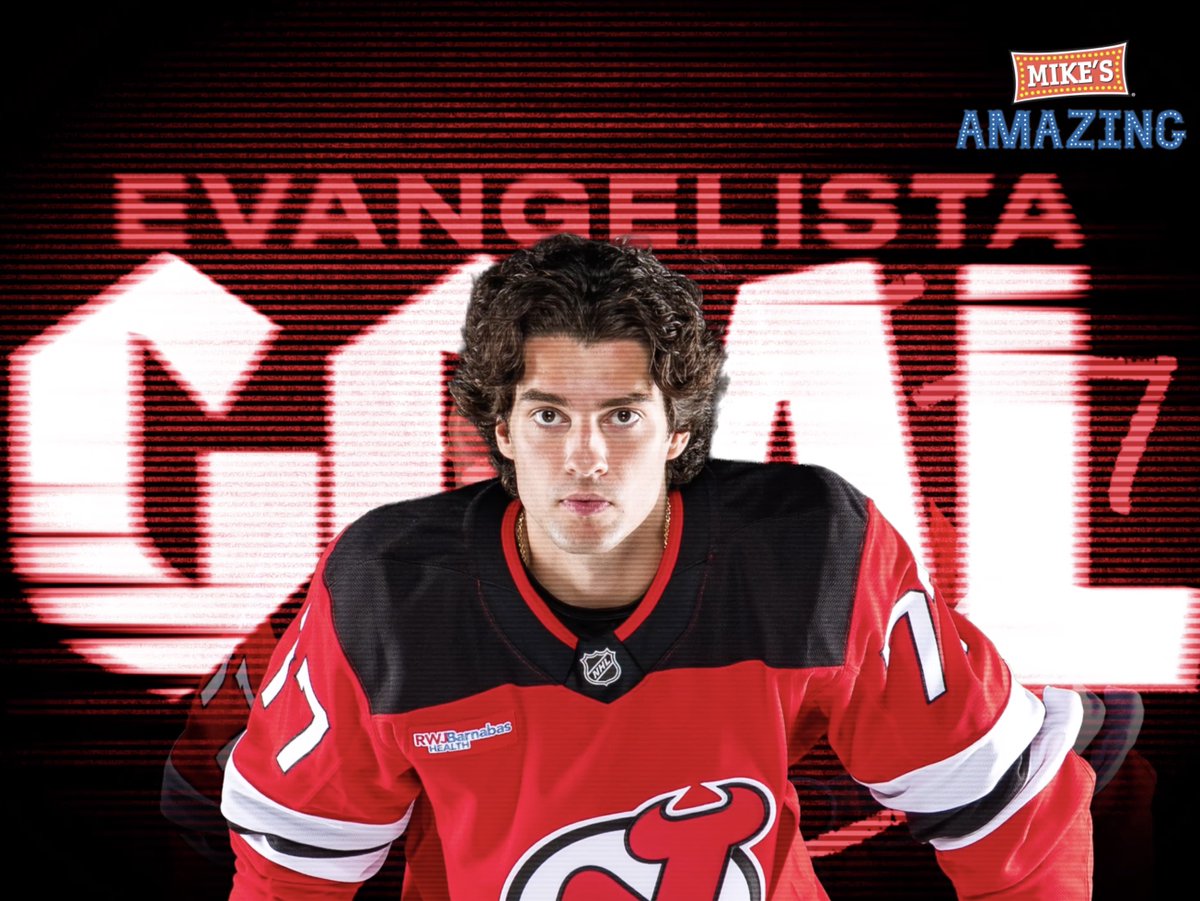 Hockey player Luke Evangelista poses in his red New Jersey Devils jersey (#77), with promotional text reading 'MIKE'S AMAZING EVANGELISTA 77' behind him.