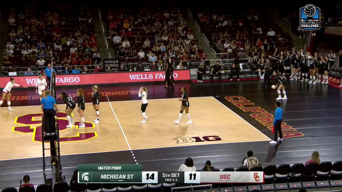 A college volleyball match between Michigan State and USC is underway, with Michigan State leading 14-11 during match point in the 5th set.