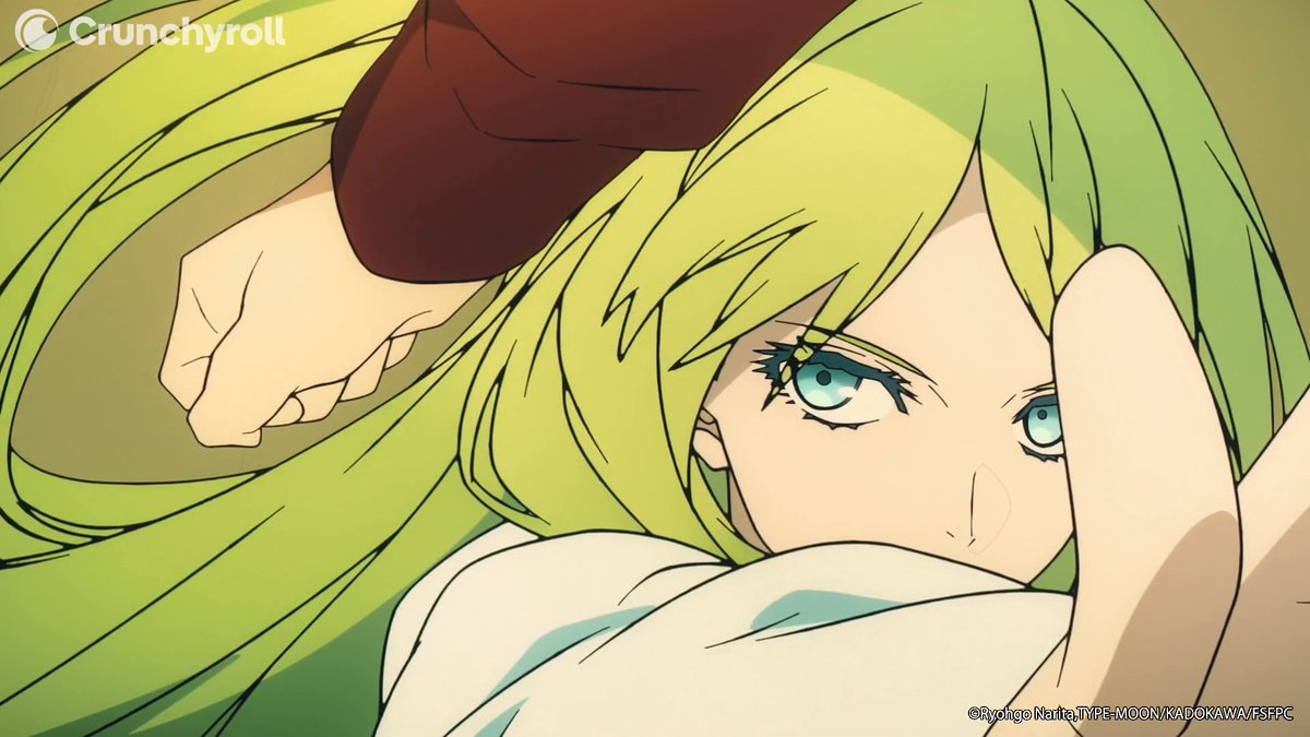 A close-up anime still shows a green-haired character (Enkidu) with striking teal eyes lying down as a clenched fist hovers above their face, with "Crunchyroll" watermark in the top-left and "©Ryohgo Narita,TYPE-MOON/KADOKAWA/FSFC" credit in the bottom-right, capturing an intense moment from the Fate/strange Fake series.