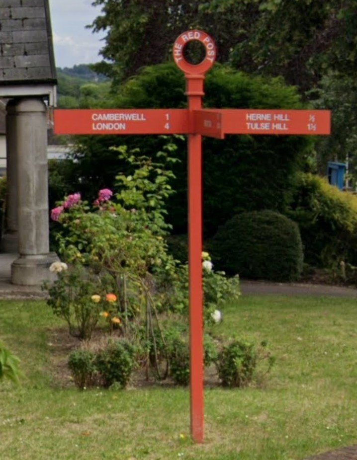 Knowledgepoint's tweet photo. Red Post Hill, Junction with Denmark Hill.

The street's name is derived from an old landmark signpost that stood at the junction of the former Ashpole Road and Denmark Hill. 

Documented as early as 1768, the signpost was inexplicably painted bright red and served as an early precursor to modern street signs, indicating local travel distances. 

The original post vanished sometime before 1875, but the Dulwich Society stepped in to restore this quirky bit of history by erecting a modern replica red post in October 2010 to mark its historical site.