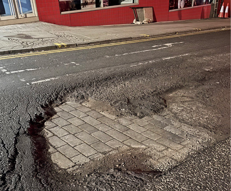 archpng's tweet photo. This road is so neglected it’s going back to the Victorian era.

A pothole on Seely Road in Nottingham has worn through the modern asphalt, revealing the old stone-sett road beneath it.

Stone-sett streets were common across British cities in the 19th and early 20th centuries, and many were later simply covered with asphalt rather than removed.