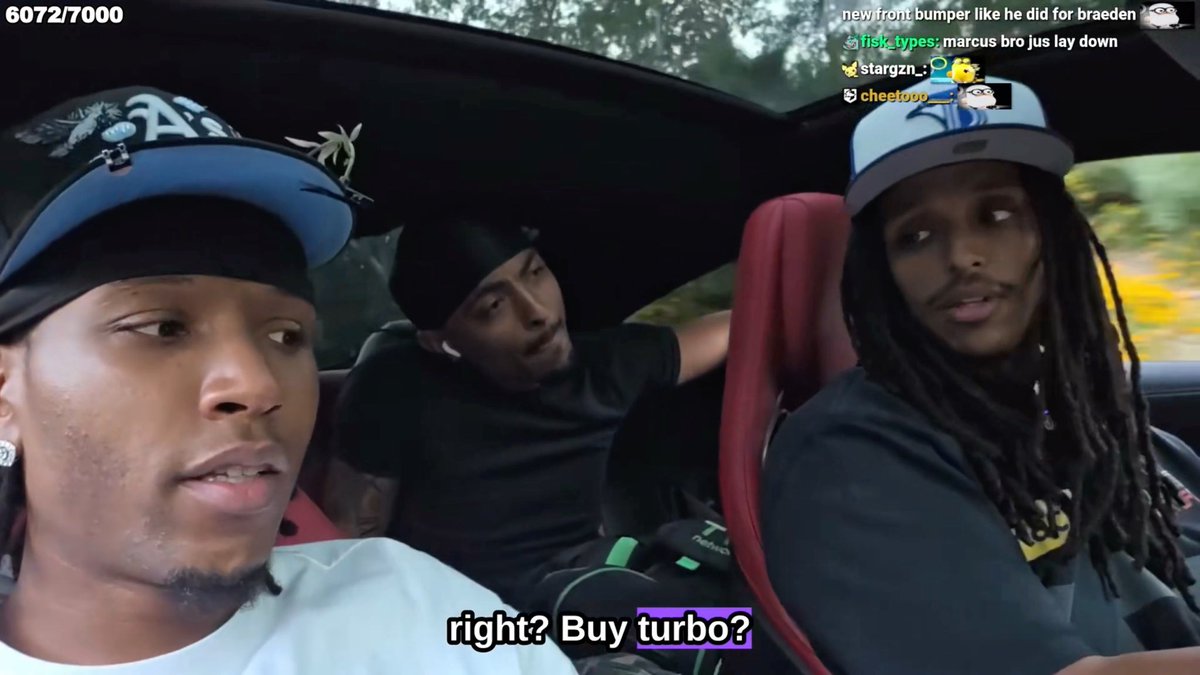 Three people are sitting inside a car, with the man on the left wearing a patterned baseball cap and white shirt, while the man on the right with long dreadlocks and a gray cap says "right? Buy turbo?" according to the on-screen text. The scene appears to be a livestream with 6072/7000 viewers and chat messages mentioning "marcus bro jus lay down" and references to a front bumper, connecting to the post about Silky's shock during the ride.