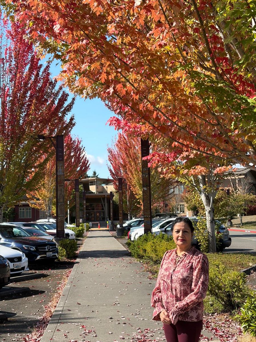 lakshmiunwomen's tweet photo. The Fall of Colours
Seattle, in a fall of colours — and for a while, I stood inside autumn’s own masterpiece.

The city caught fire without a flame-
the trees simply remembered how to glow.
Crimson climbed the branches,
amber spilled into the afternoon,
and every leaf became a little sunset
refusing to leave quietly.

Autumn had arrived like a master painter,
dipping its brush in wine, copper and gold,
turning ordinary streets into galleries
and pavements into carpets of fallen light.

I stood beneath that burning canopy
and watched summer loosen its hold—
not with sorrow, but with splendour.

Perhaps that is autumn’s loveliest wisdom:
that letting go need not be colourless;
sometimes, the most beautiful fall
is the one that leaves the world ablaze. 🍁