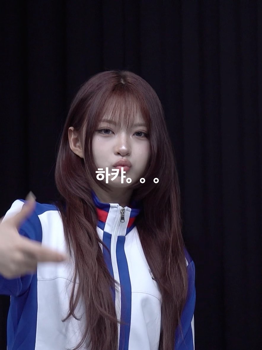 A portrait of a young woman with long brown hair wearing a blue and white track jacket, with Korean text '하카...' overlaid on the image.