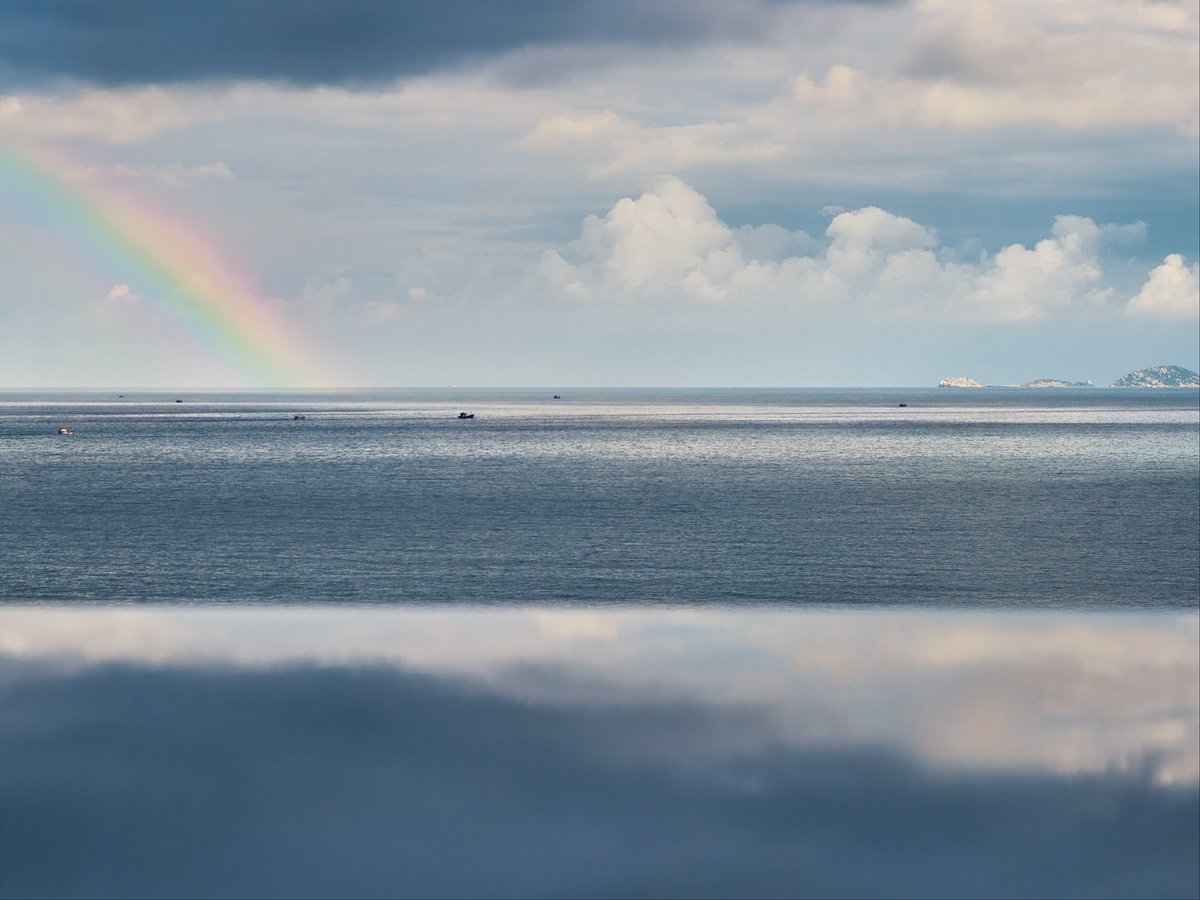 ashok_viga's tweet photo. From the cliffside villas of @mia_nhatrang, the ocean meets the sky in an endless horizon. After soft rain veiled the bay in silver, a radiant rainbow appeared, a serene, timeless moment of nature’s finest luxury. https://t.co/1RwP6ALeBL