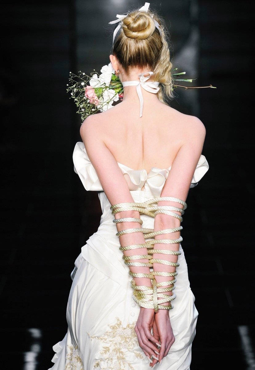 pmamtraveller's tweet photo. The dramatic ruffled white bridal gown with rope-wrapped arms and a floral gag from Samuel Cirnansck's Spring/Summer 2012 collection shown at São Paulo Fashion Week. https://t.co/0mGDkfS98A