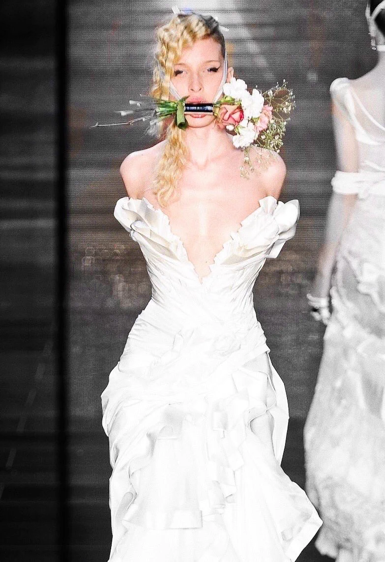The dramatic ruffled white bridal gown with rope-wrapped arms and a ...