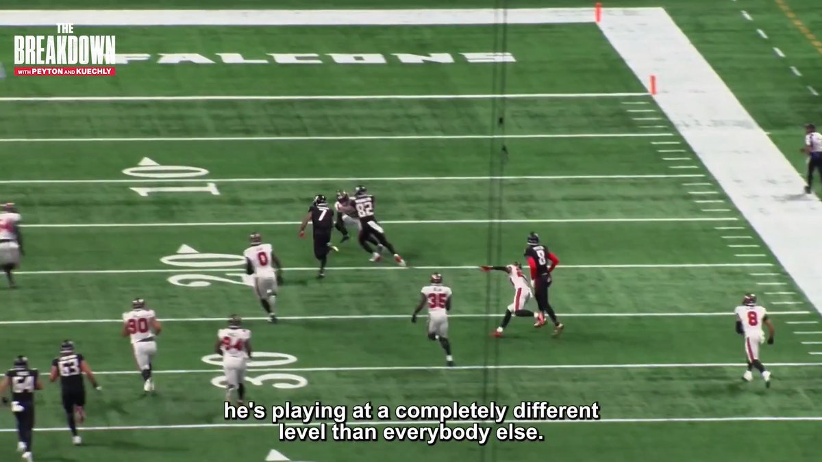 A football player in a black jersey (#7) makes a play in open field with "FALCONS" visible on the sideline, as the caption "he's playing at a completely different level than everybody else" highlights the athletic performance featured on ESPN+'s "The Breakdown with Peyton and Kuechly."