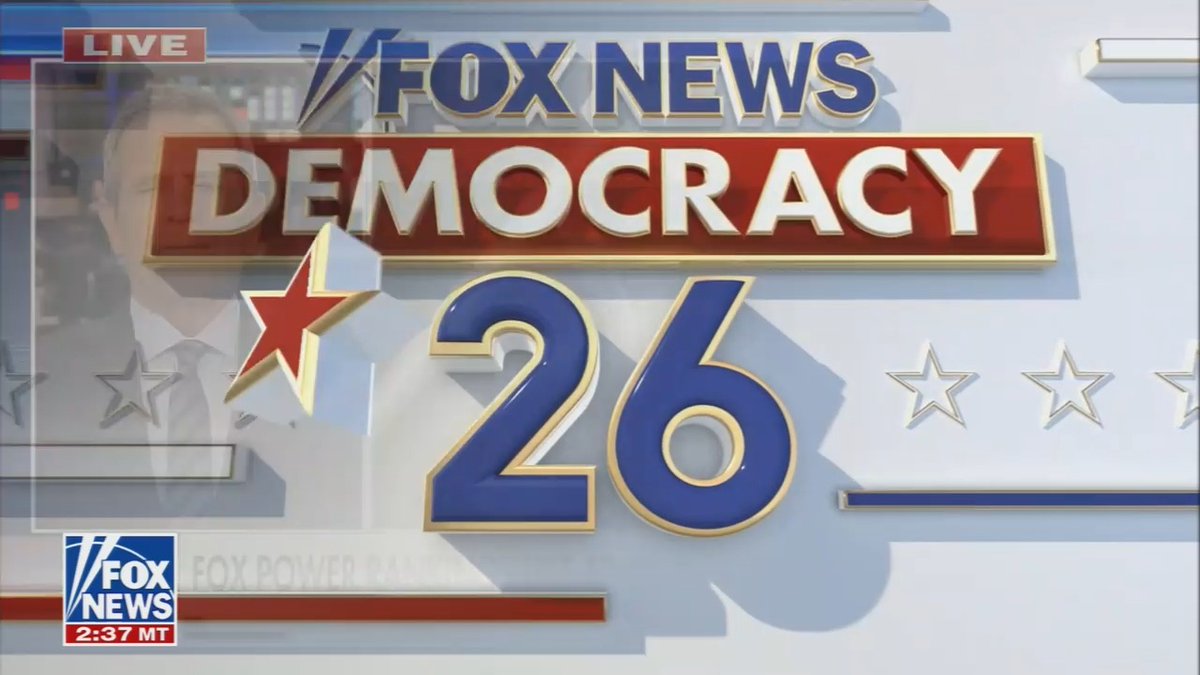 The image shows a Fox News "Democracy 26" live broadcast graphic featuring a red "LIVE" tag in the upper left, the Fox News logo, and a timestamp of "2:37 MT" in the lower corner. A faded image of a man in a suit and tie appears on the left side of the patriotic red, white, and blue-themed graphic, which relates to the post by providing visual context from the Fox News segment discussing the Trump administration's taxpayer-funded TV ads.
