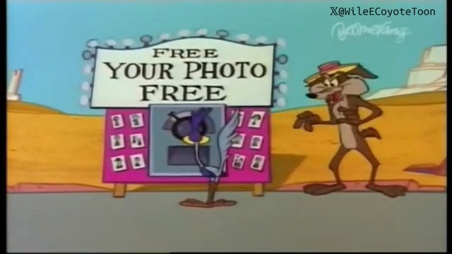 A still from an animated cartoon, likely Wile E. Coyote and the Road Runner, featuring a sign reading 'FREE YOUR PHOTO FREE' in a desert landscape, with a Twitter handle '@WileECoyoteToon' in the corner.